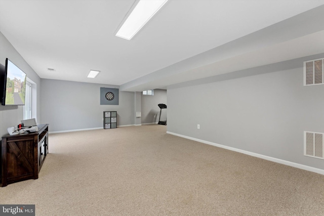 basement with light carpet and baseboards