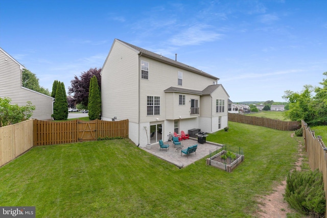 rear view of house featuring a patio and a gate