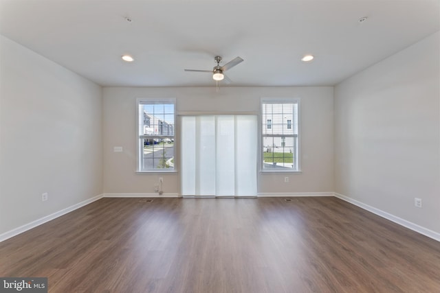 spare room featuring healthy amount of natural light, a ceiling fan, dark wood-style floors, and recessed lighting