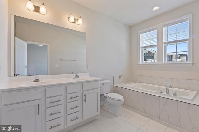 bathroom with marble finish flooring, a garden tub, double vanity, and toilet