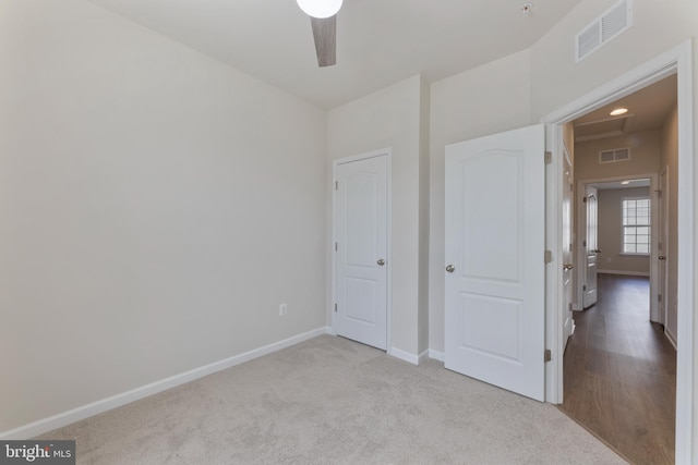 unfurnished bedroom featuring baseboards, carpet, and ceiling fan