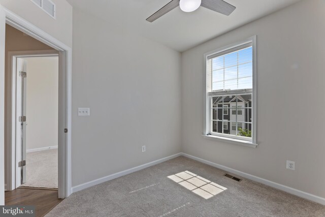 unfurnished room with ceiling fan, baseboards, and carpet flooring