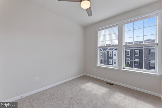 spare room featuring baseboards, carpet flooring, and a ceiling fan