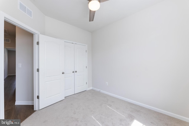 unfurnished bedroom featuring baseboards, a closet, carpet flooring, and ceiling fan