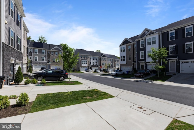 view of asphalt street with a residential view and sidewalks