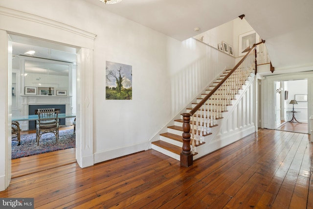 1129 Delaplane Grade Rd, Upperville, VA 20184 - stairway featuring wood-type flooring and a glass covered fireplace