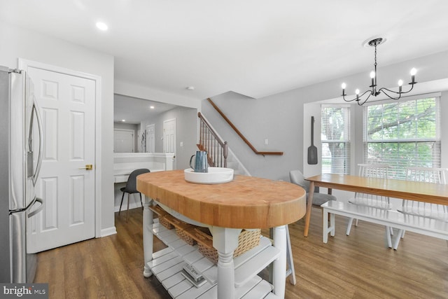 dining area with dark wood-style floors, stairs, a chandelier, and recessed lighting