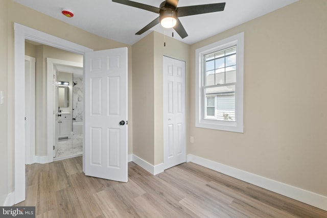 2701 Christopher Ave, Baltimore, MD 21214 - unfurnished bedroom featuring light wood-type flooring, a closet, and a ceiling fan