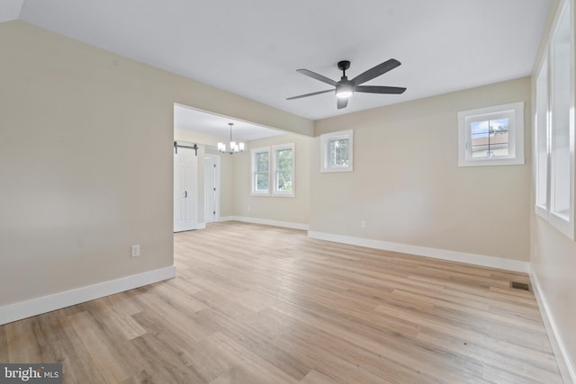 2701 Christopher Ave, Baltimore, MD 21214 - unfurnished room featuring light wood finished floors, a ceiling fan, a barn door, and a chandelier