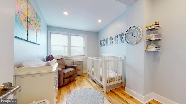 4914 3rd St NW, Washington, DC 20011 - bedroom featuring light wood-style flooring, baseboards, a crib, and recessed lighting