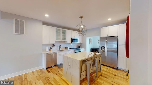4914 3rd St NW, Washington, DC 20011 - kitchen featuring a sink, stainless steel appliances, light wood-style flooring, and visible vents