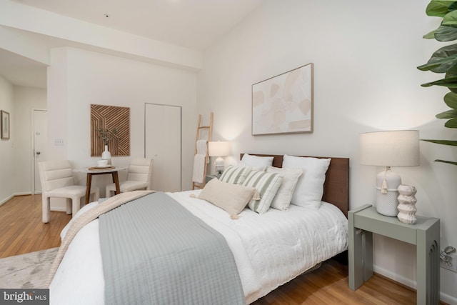 bedroom featuring wood finished floors and baseboards
