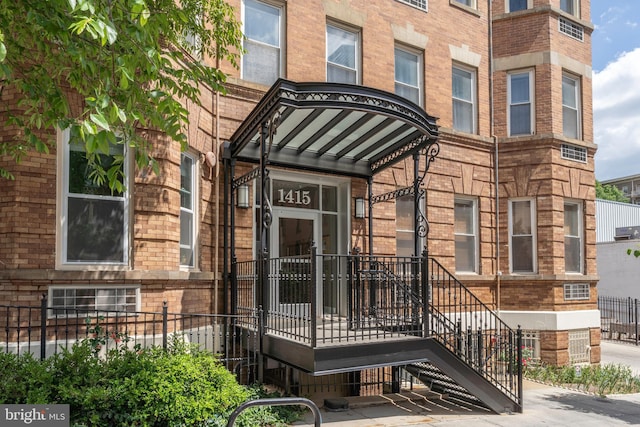 doorway to property with brick siding