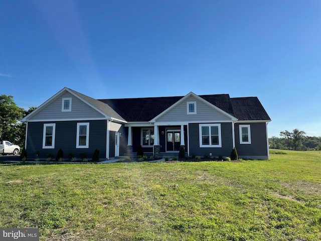 view of front facade featuring covered porch and a front yard