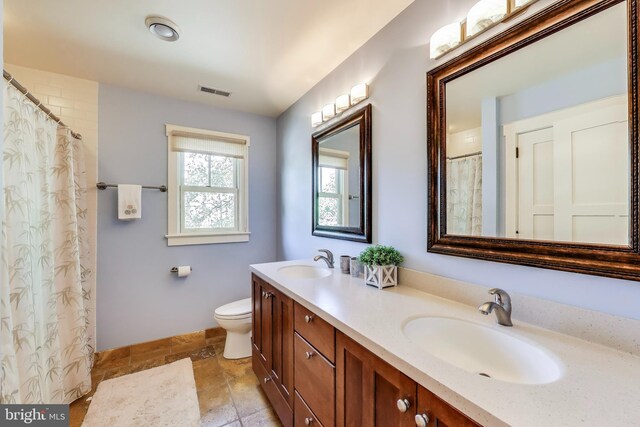 3906 Halsey St, Kensington, MD 20895 - bathroom featuring double vanity, toilet, baseboards, and a shower with shower curtain