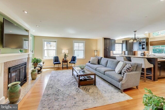 3906 Halsey St, Kensington, MD 20895 - living area featuring a chandelier, a high end fireplace, light wood-style floors, recessed lighting, and baseboards