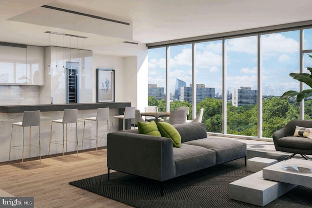 living room with a wealth of natural light, expansive windows, a view of city, and wood finished floors