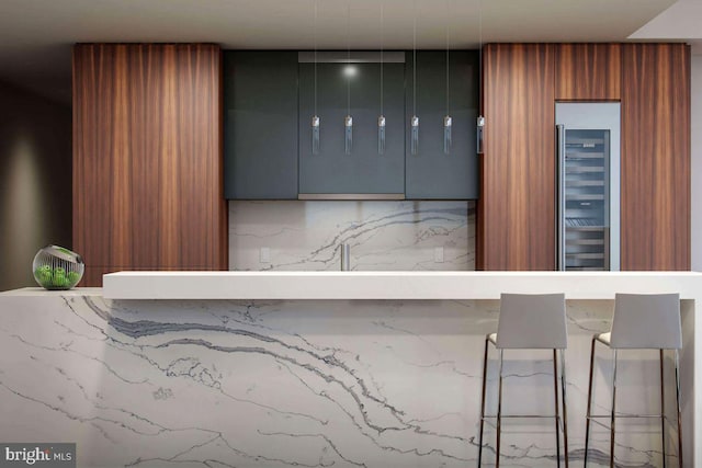 interior space with brown cabinetry and beverage cooler