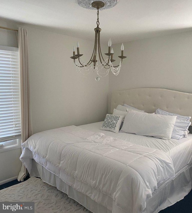 bedroom featuring an inviting chandelier