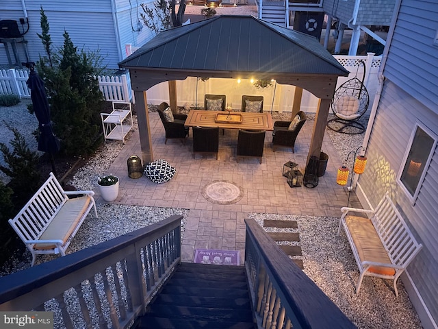 view of patio / terrace with an outdoor hangout area, a gazebo, and fence