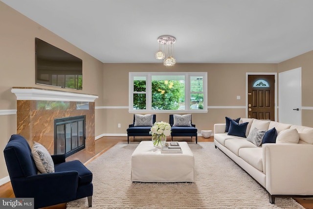 living area featuring baseboards, a fireplace, and wood finished floors