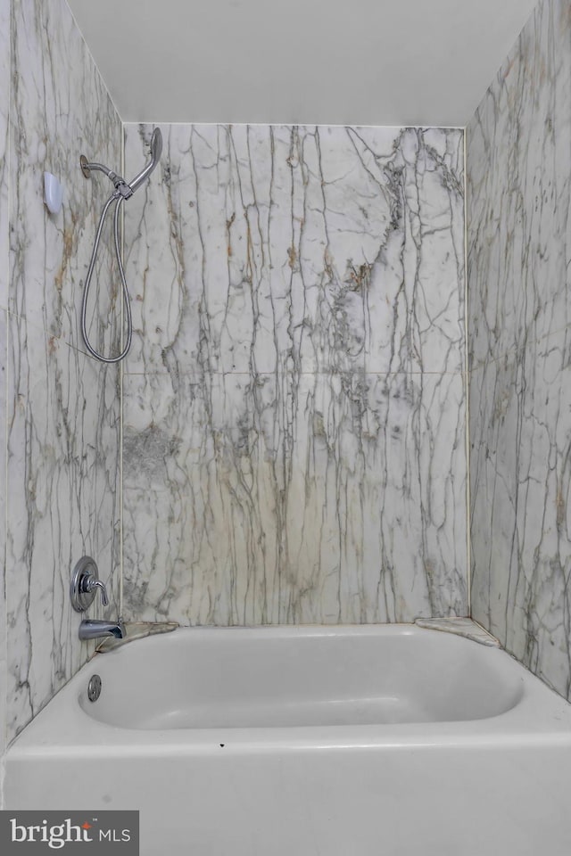 bathroom with bathing tub / shower combination