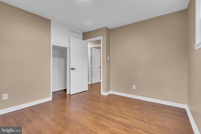 unfurnished bedroom with baseboards and light wood finished floors