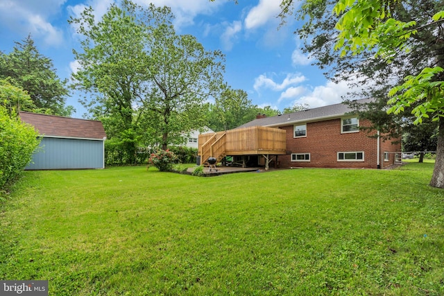 view of yard featuring an outbuilding and a wooden deck
