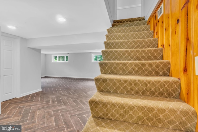 staircase featuring baseboards, visible vents, and recessed lighting