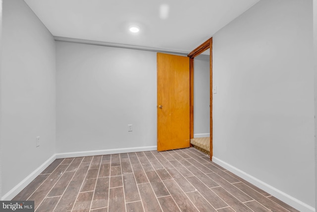 unfurnished room featuring baseboards and wood finished floors