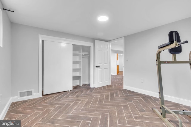 unfurnished bedroom with baseboards, a closet, and visible vents