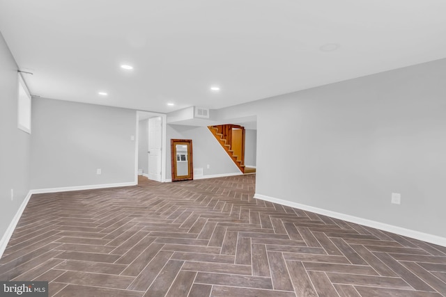 finished below grade area with stairway, baseboards, and visible vents