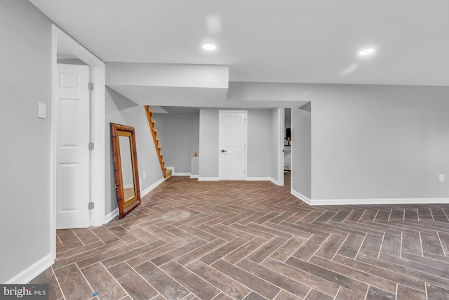 finished basement featuring stairway, baseboards, and recessed lighting