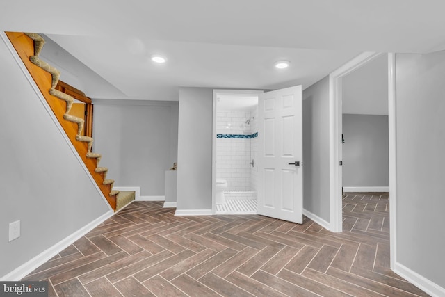 finished basement with stairway, baseboards, and recessed lighting