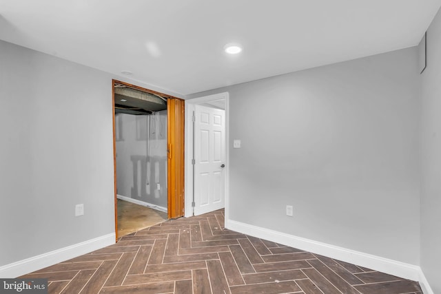 unfurnished room with baseboards and recessed lighting