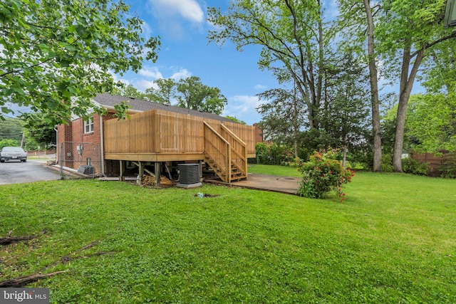 view of yard with cooling unit, stairway, and a deck