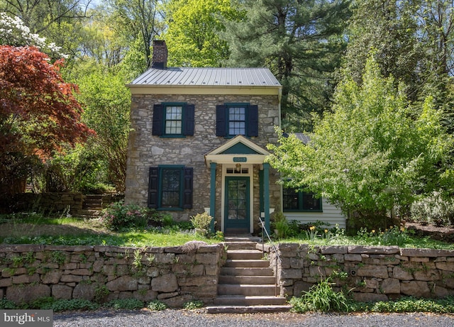 2957 River Rd, New Hope, PA 18938 - colonial-style house featuring metal roof, stone siding, a standing seam roof, and a chimney