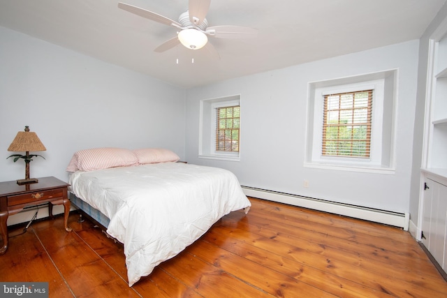 2957 River Rd, New Hope, PA 18938 - bedroom with a baseboard heating unit, hardwood / wood-style floors, and ceiling fan