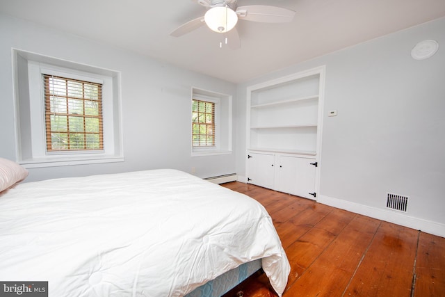 2957 River Rd, New Hope, PA 18938 - bedroom with wood finished floors, visible vents, baseboards, ceiling fan, and a baseboard radiator