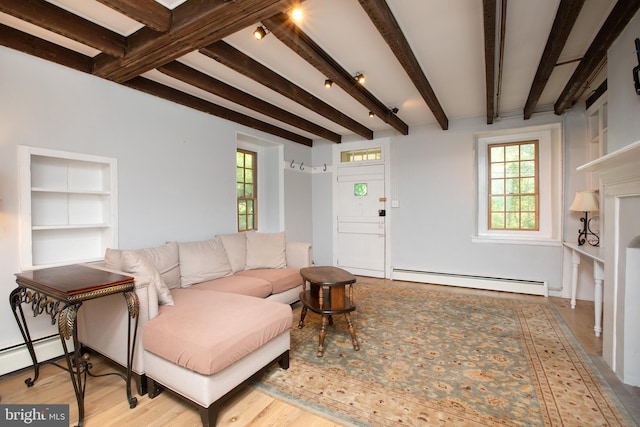 2957 River Rd, New Hope, PA 18938 - living area with beamed ceiling, a healthy amount of sunlight, and a baseboard heating unit