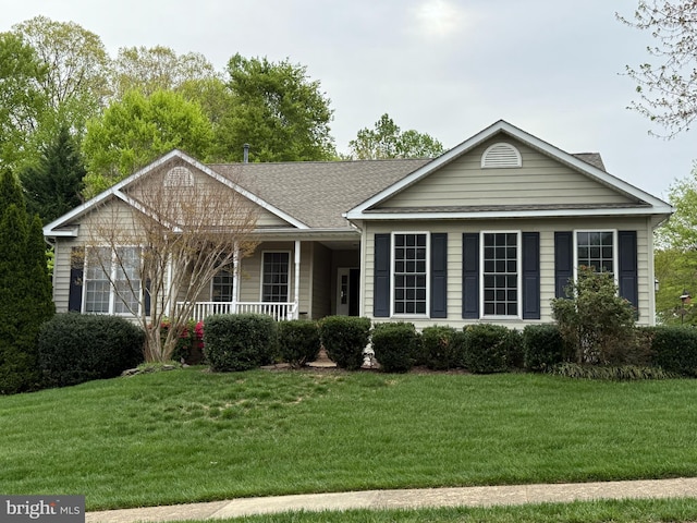 ranch-style home with a front lawn, a porch, and roof with shingles