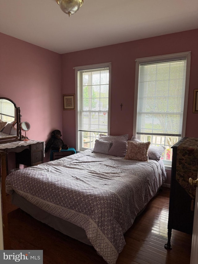 bedroom with hardwood / wood-style flooring