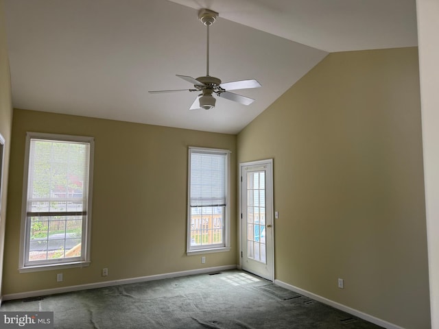 spare room with carpet floors, baseboards, vaulted ceiling, and ceiling fan