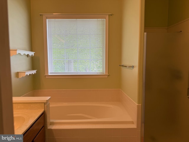 full bathroom with a stall shower, vanity, and a bath