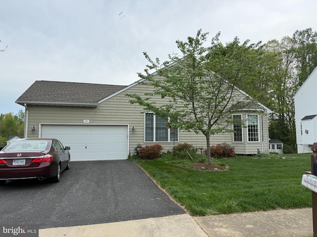obstructed view of property with asphalt driveway, a garage, a shingled roof, and a front lawn