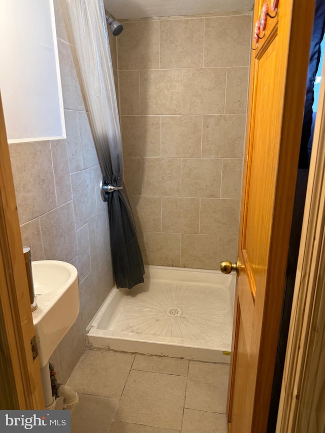 full bath with tile patterned flooring and a shower stall