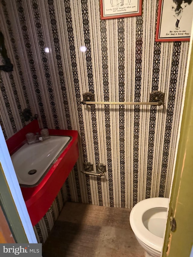 half bath featuring a sink and toilet