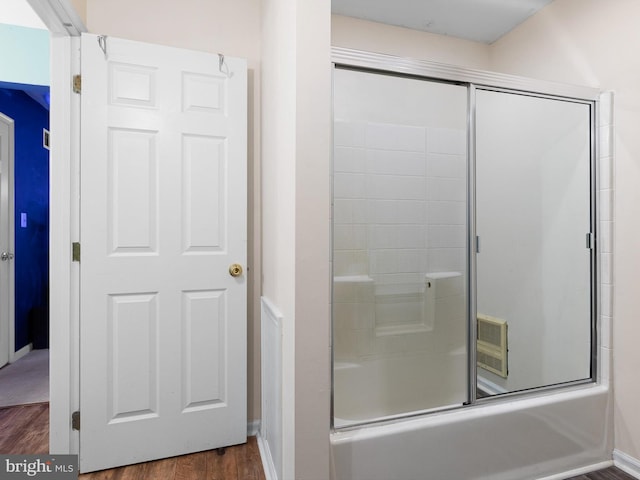full bathroom with combined bath / shower with glass door, baseboards, and wood finished floors