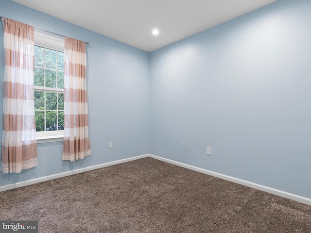 empty room with carpet flooring, baseboards, and recessed lighting