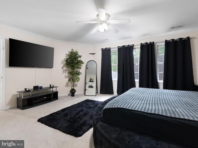 bedroom with carpet flooring, a ceiling fan, crown molding, visible vents, and baseboards